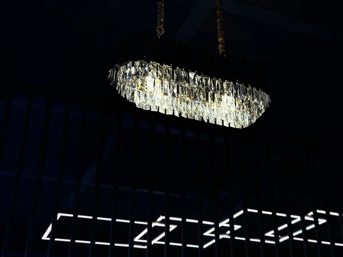 Crystal chandelier glowing above the dark Kongquer interior